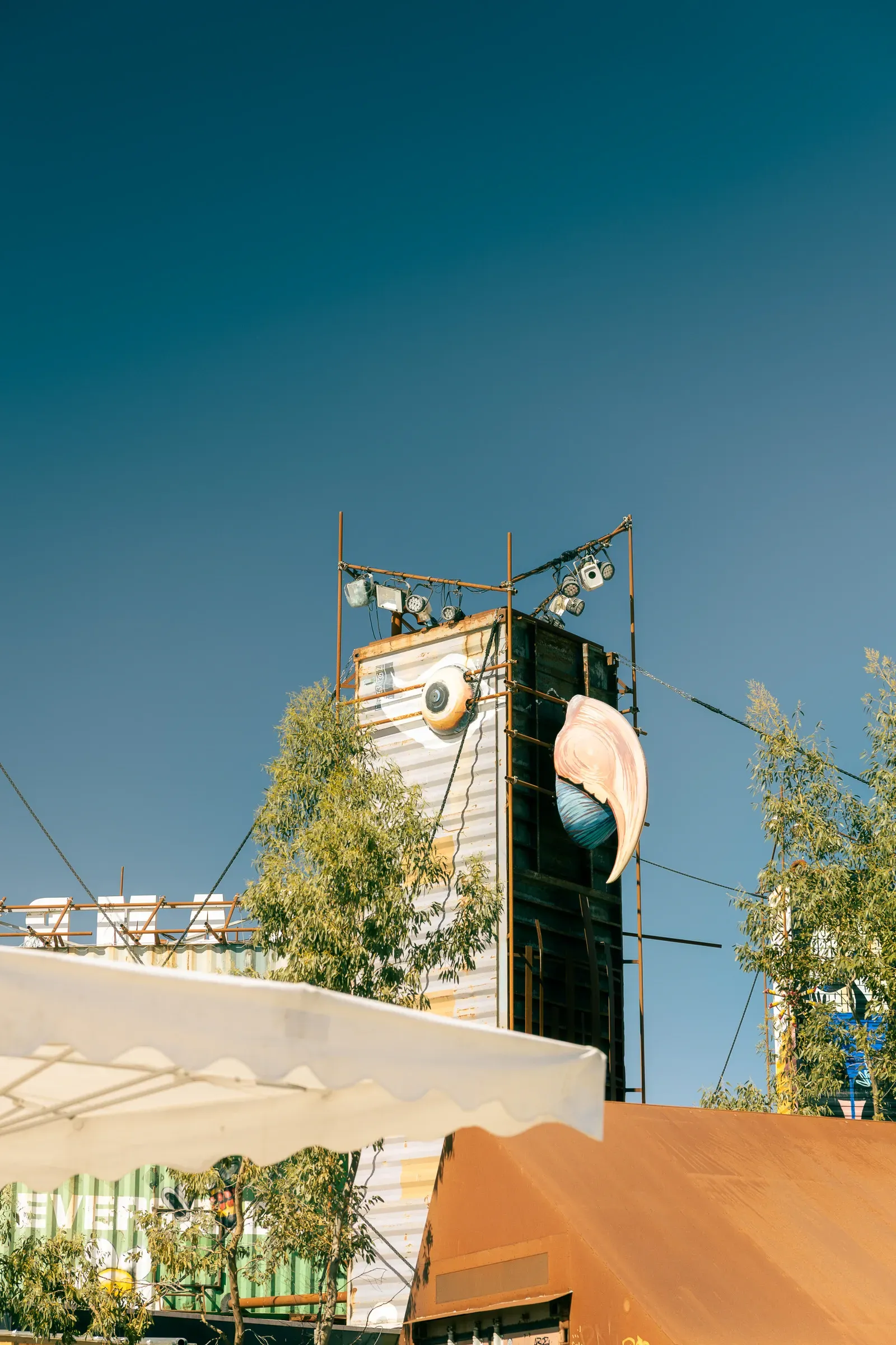 Scaffolding tower with an angel wing installation and stage spotlights, Transfer Autolargue, Nantes