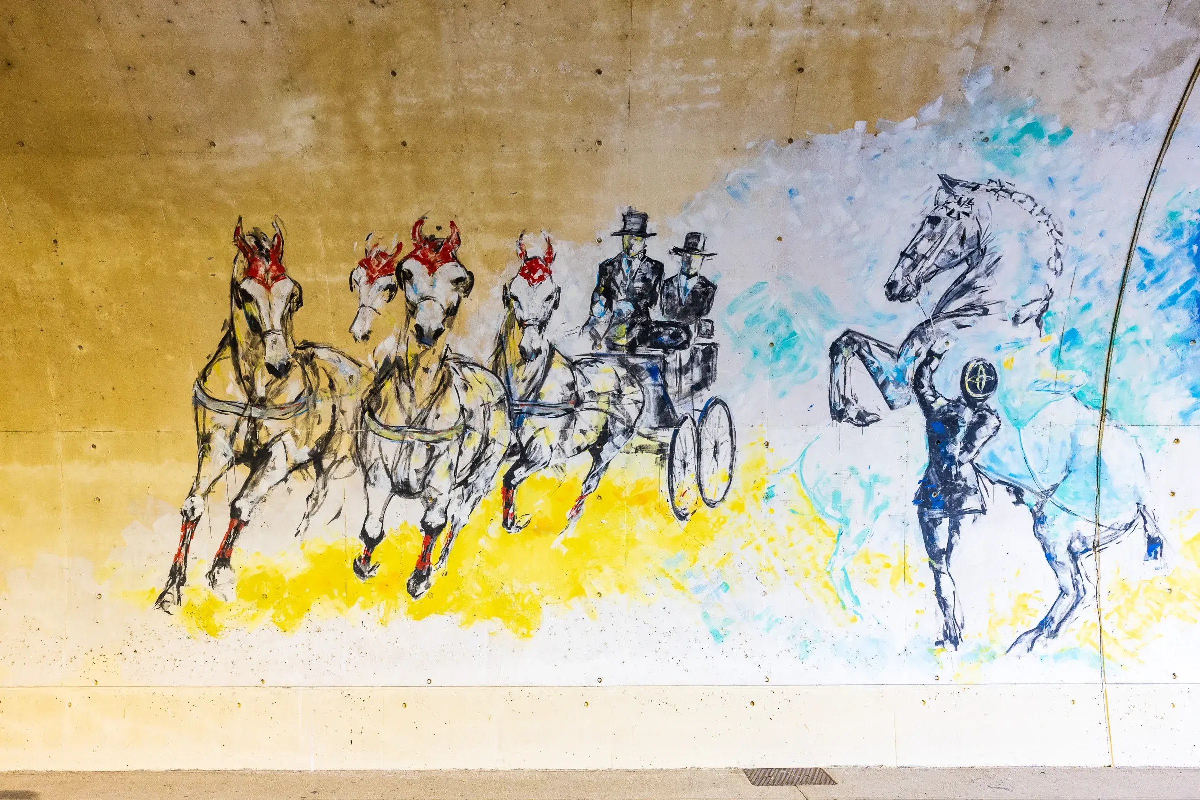 Tunnel mural section — horse-drawn carriage with a top-hatted driver and a rearing horse rendered in blue ink and yellow paint splashes, Saumur