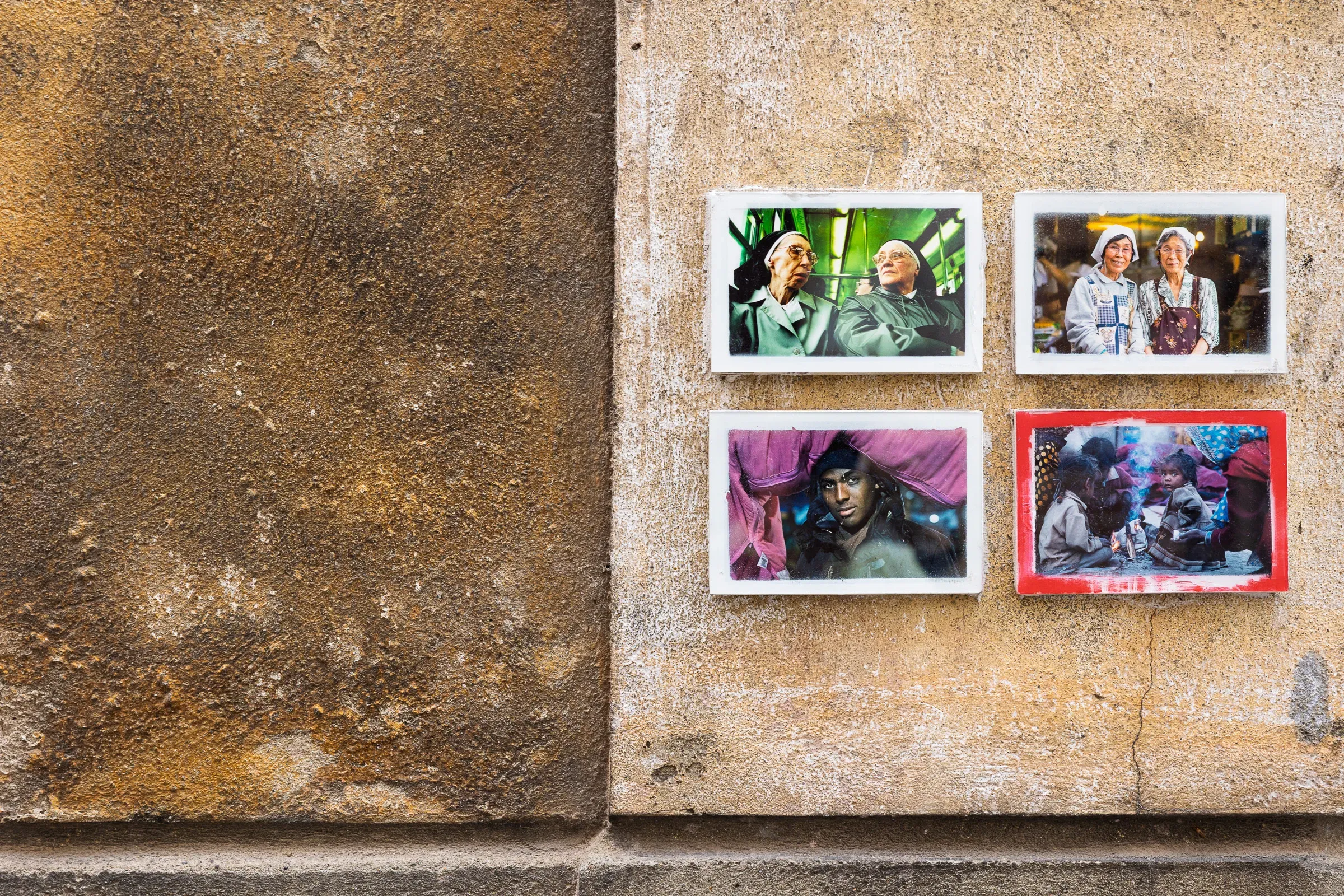 Four color photographs of people taped to a rough stone wall — two elderly women, a young man, and a group gathered around a meal, Toulouse