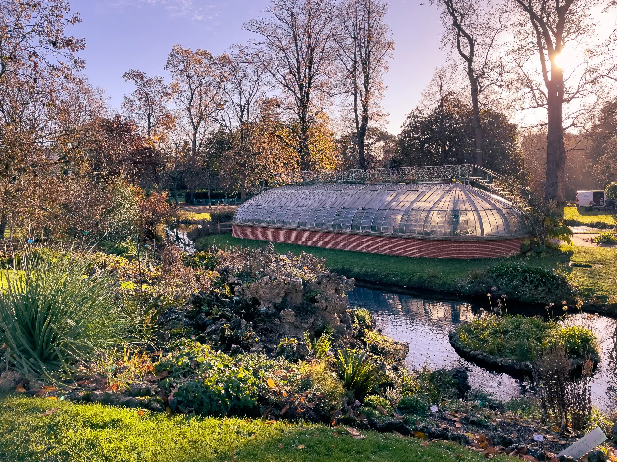 Glass greenhouse in a city garden